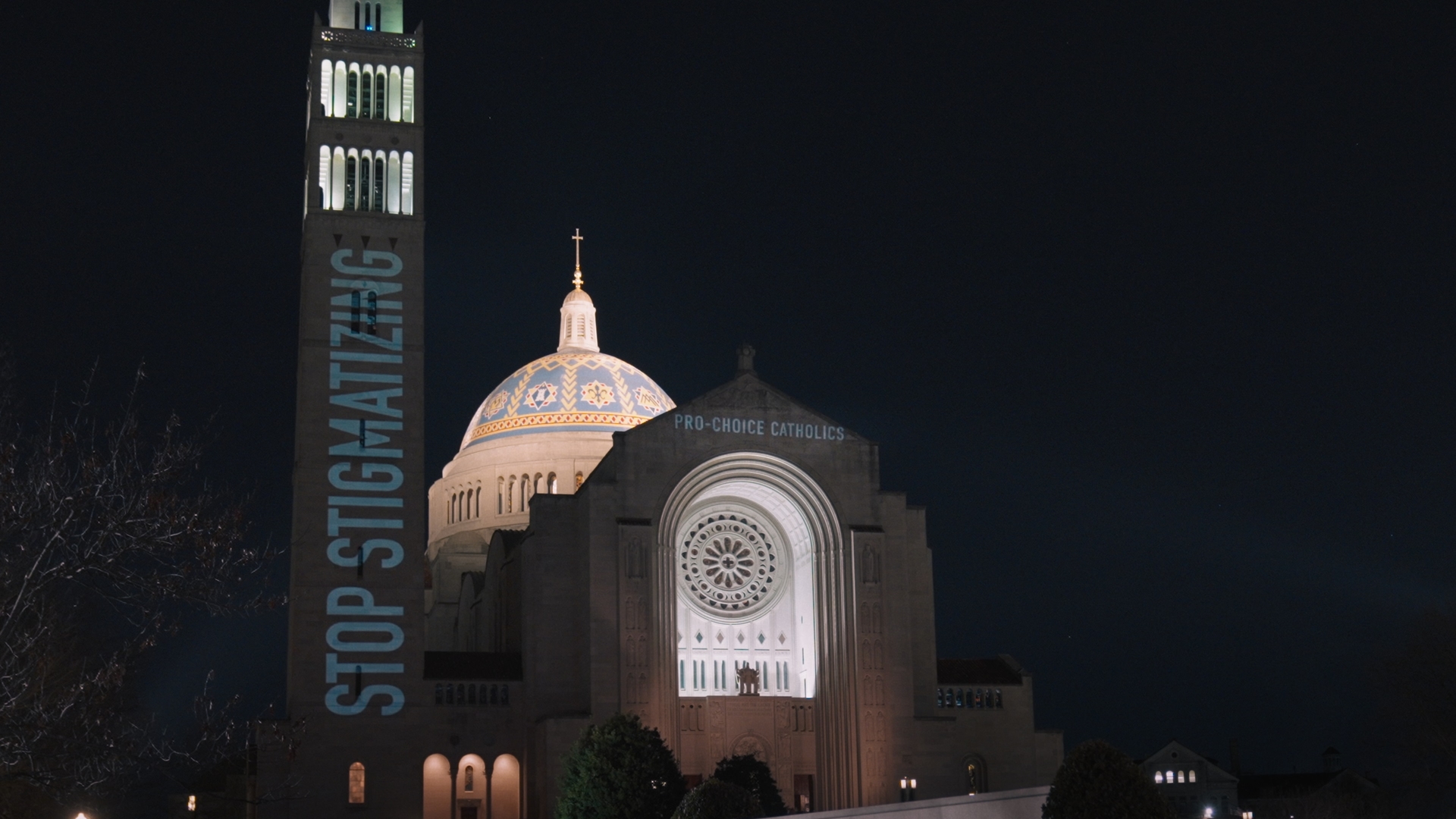 A church with the words "Stop Stigmatizing" projected on a supporting pillar